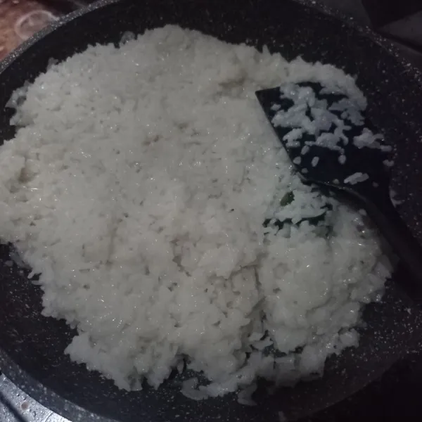 Lalu masukkan ketan kukus, aduk terus sampai meresap, diamkan selama 5 menit.