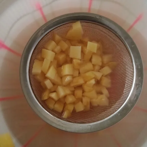 Kupas kentang, wortel kemudian potong-potong dadu kecil, rendam air agar kentang tidak menghitam.
