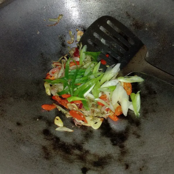Masukkan cabe dan daun bawang, tumis sebentar hingga layu