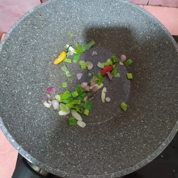Tumis bawang merah dan bawang putih sampai harum lalu masukkan daun bawang dan cabe.
