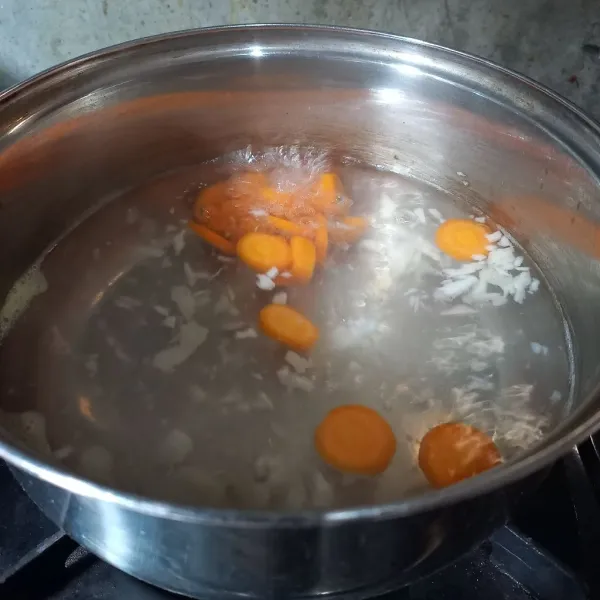 Masukkan wortel. Rebus sampai setengah matang.