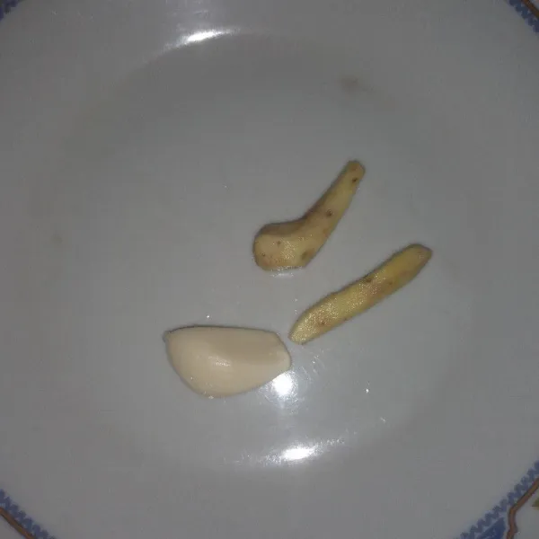 Siapkan bawang putih dan temu kunci, cuci bersih lalu geprek
