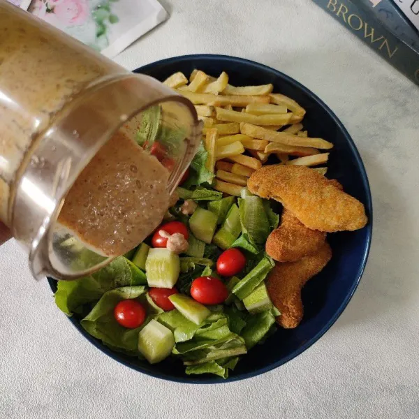 Blender kacang tanah, wijen (sisakan sedikit wijen untuk taburan), yogurt, himalayan salt, dan sedikit air, lalu proses hingga halus. Setelah itu tuang ke atas bahan sayuran.