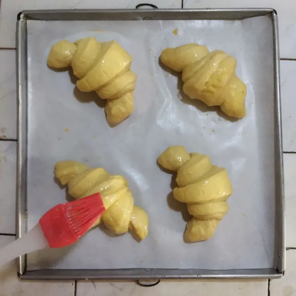 Susun diloyang yang sudah dialasi kertas roti. Diamkan selama 2-4 jam hingga mengembang 2 kali lipat. Oles dengan kuning telur. Dan panggang dengan suhu 200 derajat di api atas bawah selama 15-30 menit hingga matang kecoklatan. Angkat.