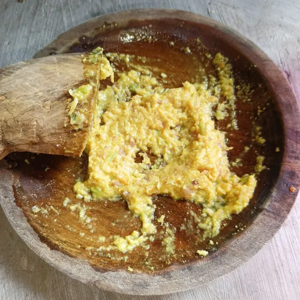 Ulek bawang merah, bawang putih, kunyit, kemiri, jahe, dan lengkuas sampai halus.