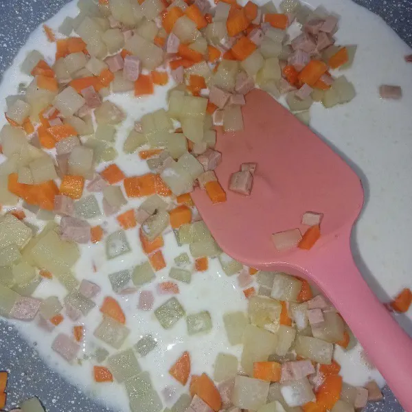 Tuang susu cair dan bawang putih bubuk aduk rata.