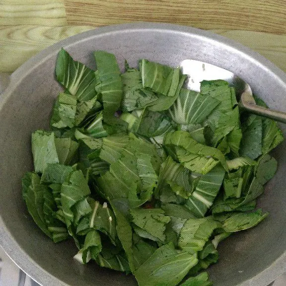 Masukkan daun pakcoy kemudian aduk.