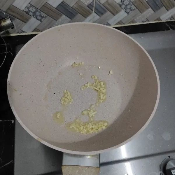 Tumis bawang putih cincang hingga harum.