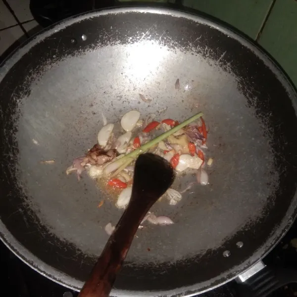 Siapkan wajan panas. Tuang sedikit minyak goreng. Masukkan bawang merah dan bawang putih, tumis hingga harum. Tambahkan lengkuas dan serai, lalu aduk rata