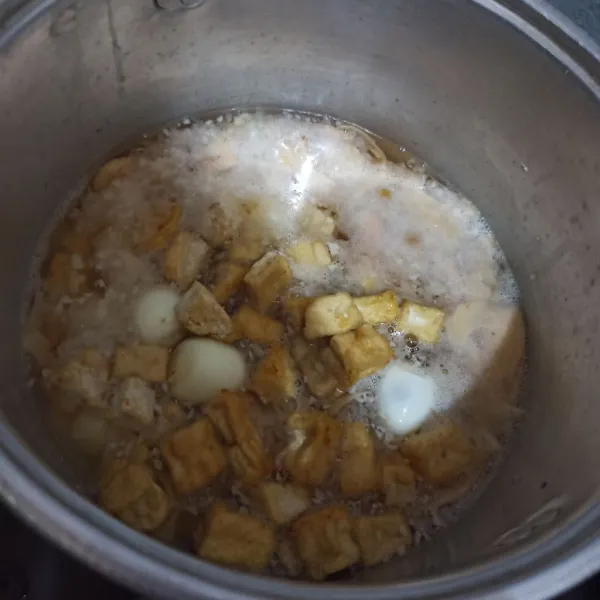 Tuang air kemudian tunggu panas. Tambahkan rebung lalu tunggu mendidih. Masukkan santan, tahu, dan telur puyuh.
