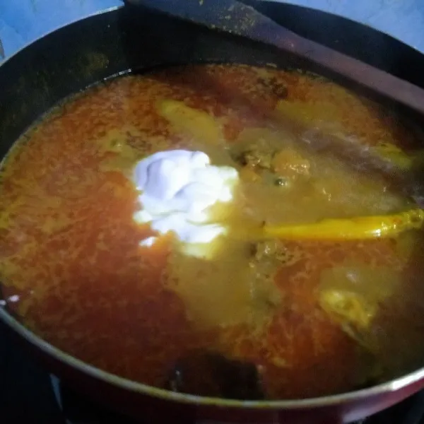 Kecilkan api kemudian masukkan santan, aduk terus sampai mendidih supaya santan tidak pecah.
