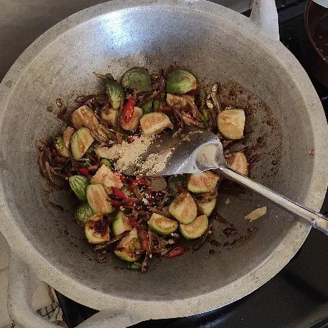 Tuang air, bumbui garam, kaldu jamur, dan kecap manis aduk rata masak sampai tingkat kematangan terong sesuai selera.