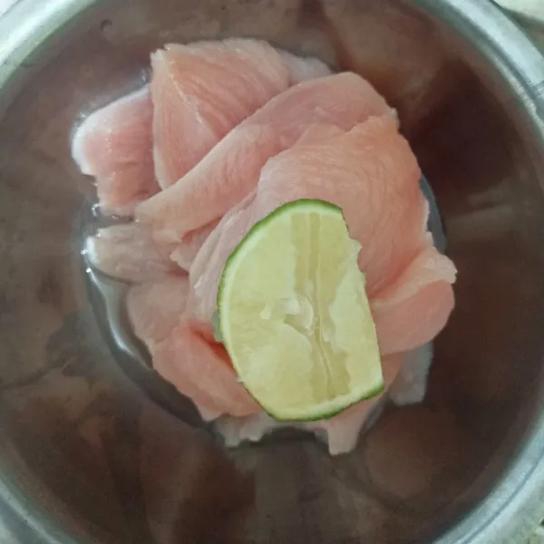 Iris tipis dada ayam dan kucuri air jeruk nipis.