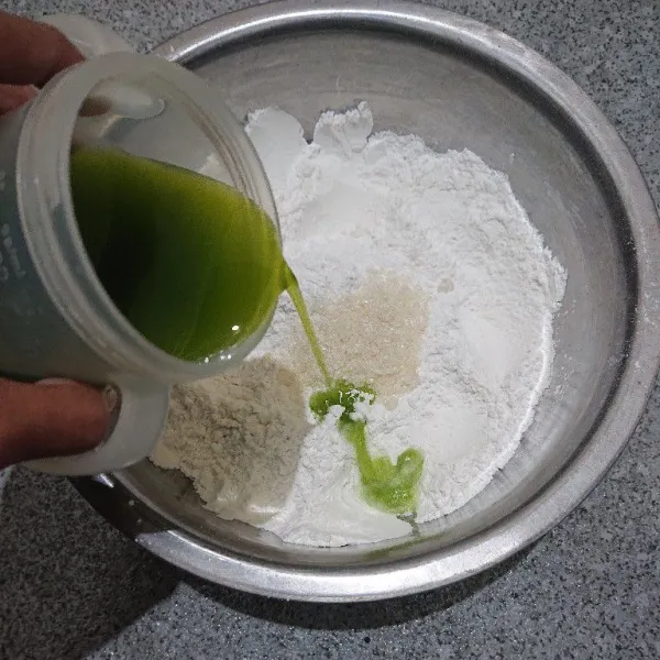 Campurkan tepung ketan, tepung beras, gula, dan garam. Kemudian tuang jus pandan sedikit demi sedikit sambil adonan diuleni