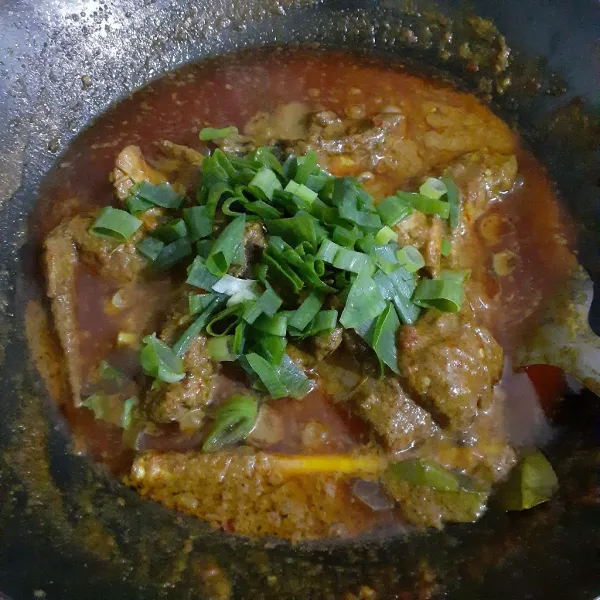 Masak hingga air menyusut. Tambahkan daun bawang, masak sesaat dan sajikan.