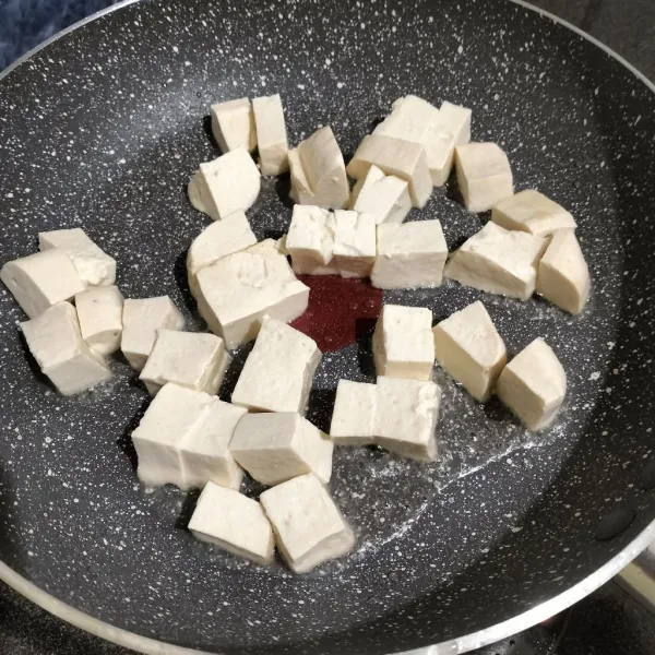 Tahu sutra dipotong dadu, lalu goreng dengan sedikit minyak hingga kulitnya kecokelatan.