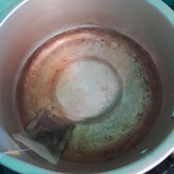 Masukkan air dan teh ke dalam panci.
