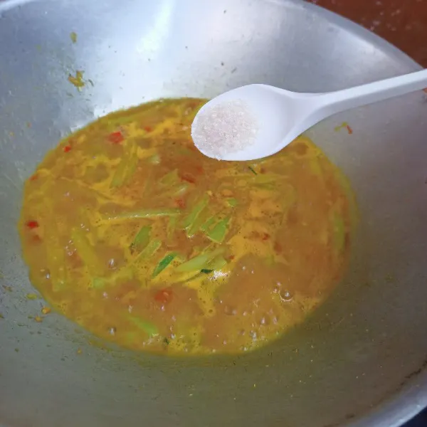 Tambahkan kunyit bubuk, gula pasir, garam, lada bubuk dan penyedap rasa kemudian koreksi rasa.