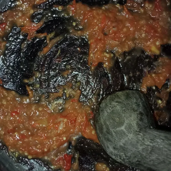 Ulek sambal hingga halus kemudian letakkan di atas ikan mujaer dan penyet perlahan.