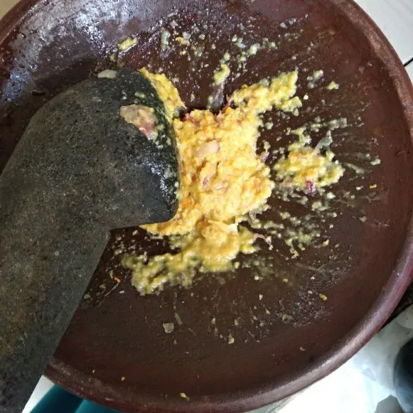 Haluskan bawang merah, bawang putih, kemiri, kunyit dan garam.