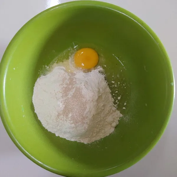 Siapkan bowl, masukkan tepung, telur, ragi instan dan gula lalu tuang air sedikit demi sedikit sambil diuleni asal tercampur rata.