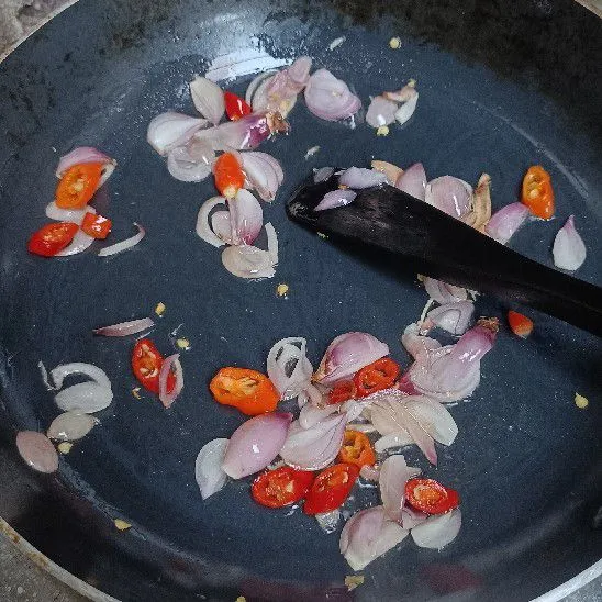 Tumis bawang merah, bawang putih, dan cabai rawit.