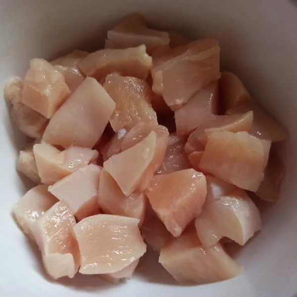 Cuci bersih daging ayam kemudian potong dadu.