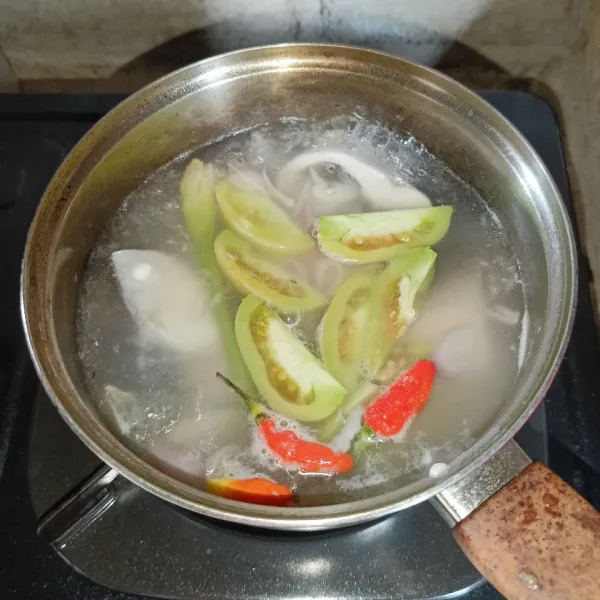 Tambahkan irisan bawang merah, bawang putih, tomat, dan cabai rawit utuh.