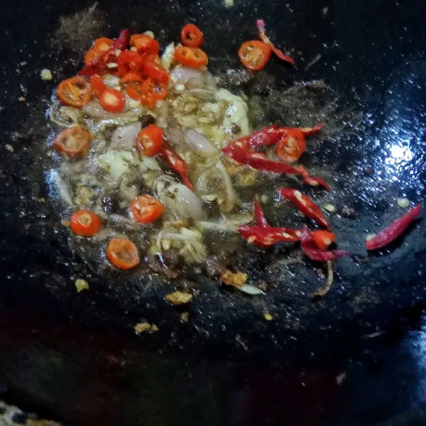 Tambahkan irisan cabe merah keriting dan cabe rawit merah, tumis hingga matang. Masukkan terasi yang sudah digoreng tadi.