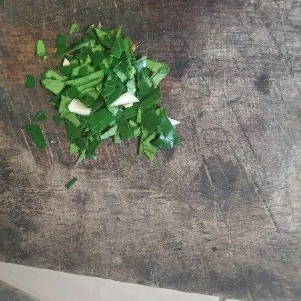 Buang tulang daun jeruk, lalu cincang kasar.