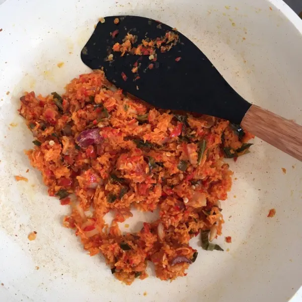 Tambahkan daun kunyit dan kelapa berbumbu. Masak sekitar 5 menit sambil terus diaduk.