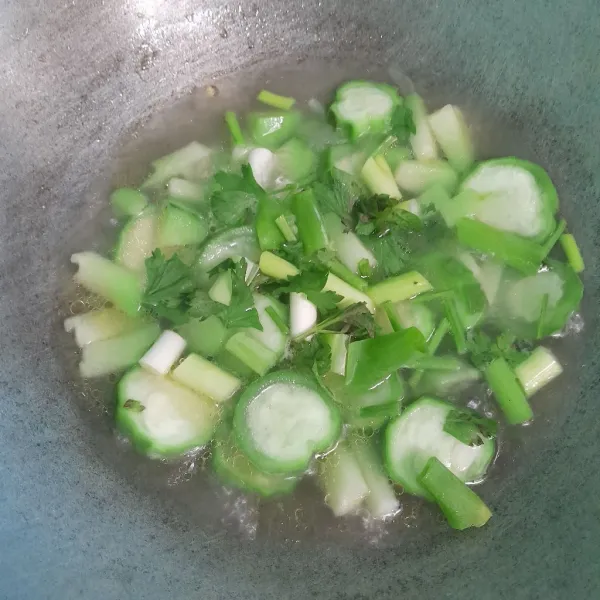 Tambahkan daun bawang, daun seledri, garam dan kaldu bubuk.