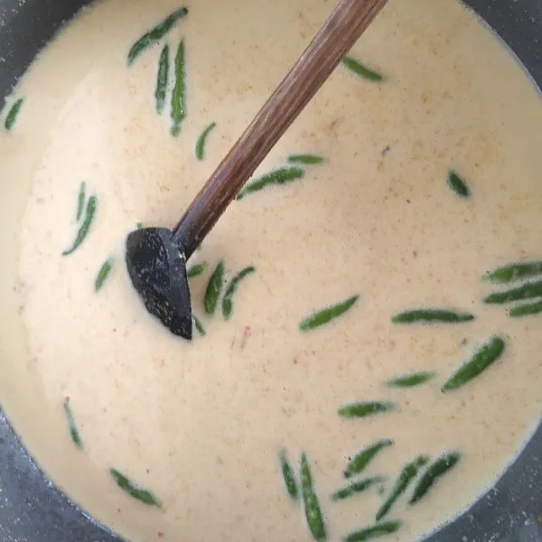 Masukkan bumbu halus, daun-daun, asam kandis, cabe rawit dan santan.