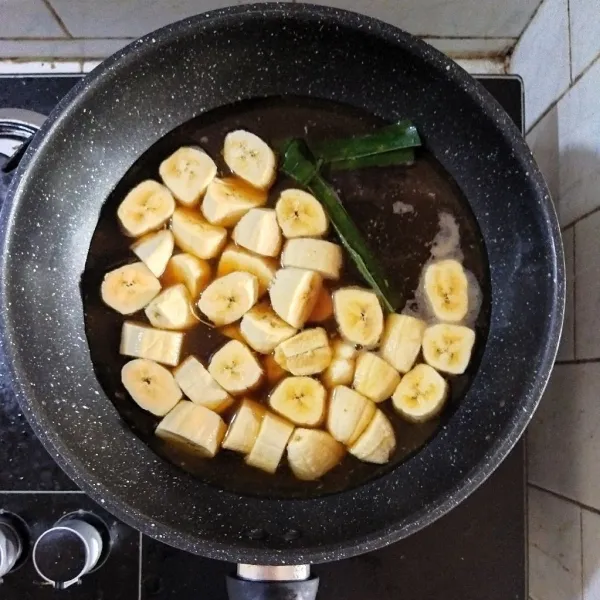 Tambahkan pisang ke dalam rebusan gula lalu tutup panci dan masak hingga mendidih dan pisang matang.