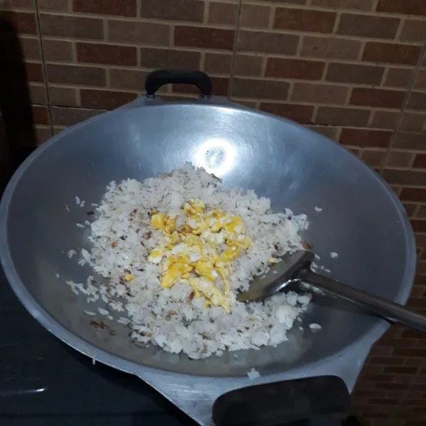 Masukkan nasi dan telur, aduk rata.