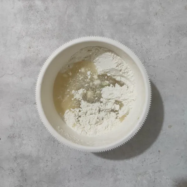 Tuang adonan bahan A ke dalam campuran tepung.
