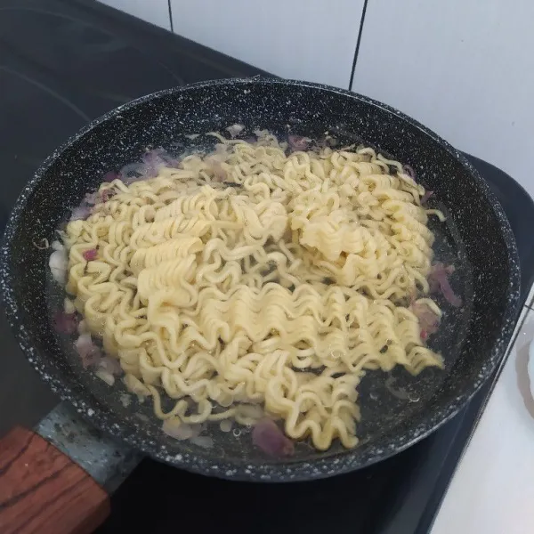Masukkan air, masak hingga mendidih lalu masukkan mie yang sudah direbus.