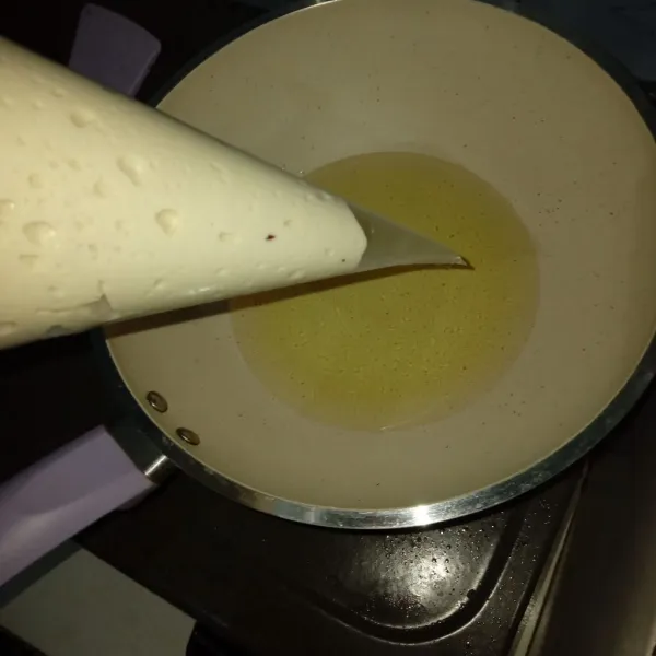 Setelah itu masukan adonan kedalam piping bag, panas kan minyak terlebih dahulu, lalu gunting ujung plastik, kemudian tekan adonan dan gunting kecil-kecil lakukan sampai adonan habis.