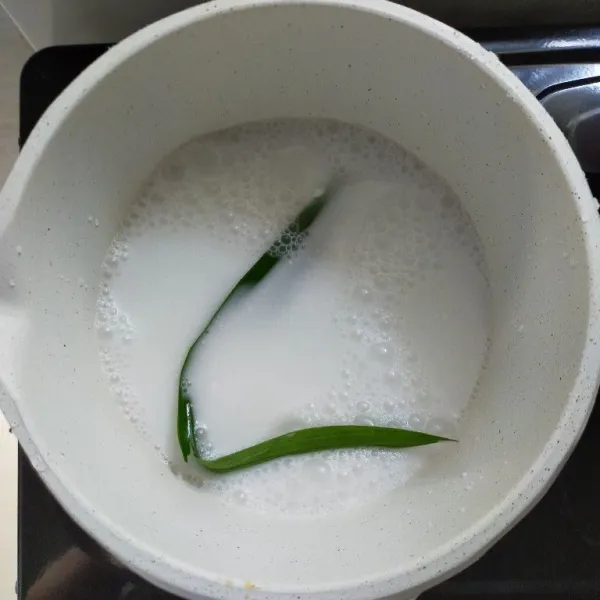 Siapkan panci, kemudian masukkan santan, susu cair dan daun pandan, aduk rata.