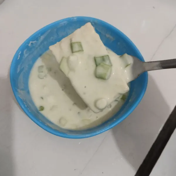 Celupkan satu persatu tempe ke dalam adonan tepung.