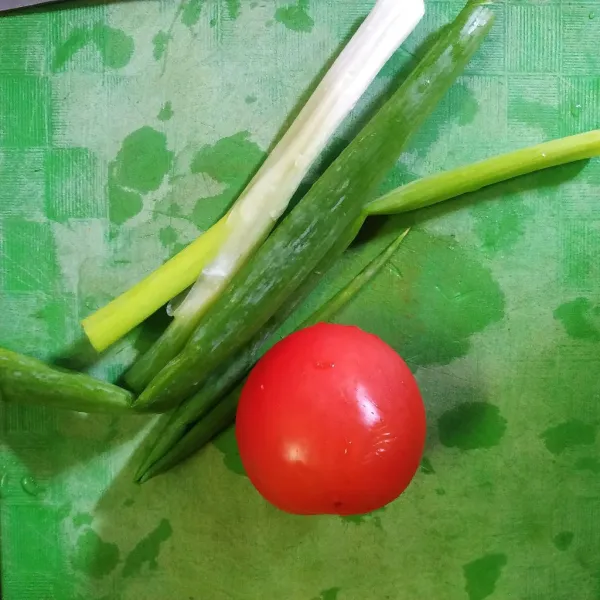 Cuci bersih tomat dan daun bawang.