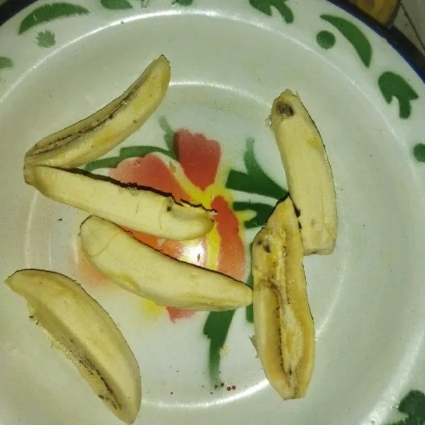 Siapkan pisang kepok kuning, potong sesuai selera, lalu gulingkan potongan pisang ke dalam tepung pelapis.