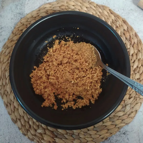 Tuang margarin cair ke remahan biskuit, lalu aduk rata.