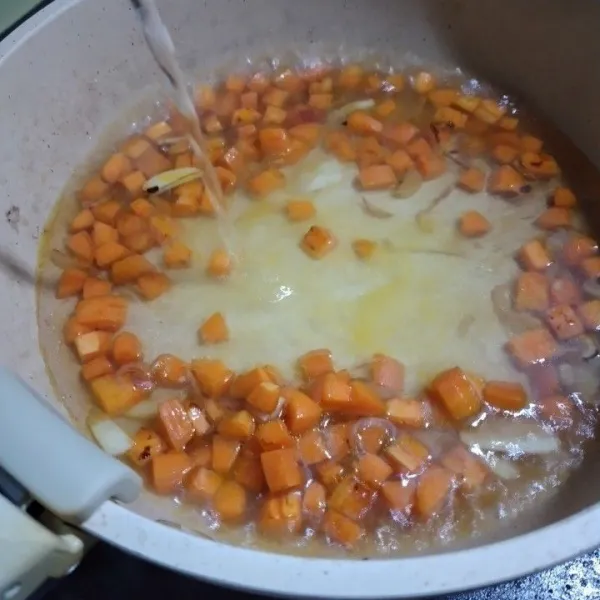 Tuang air, aduk dan masak hingga wortel matang.