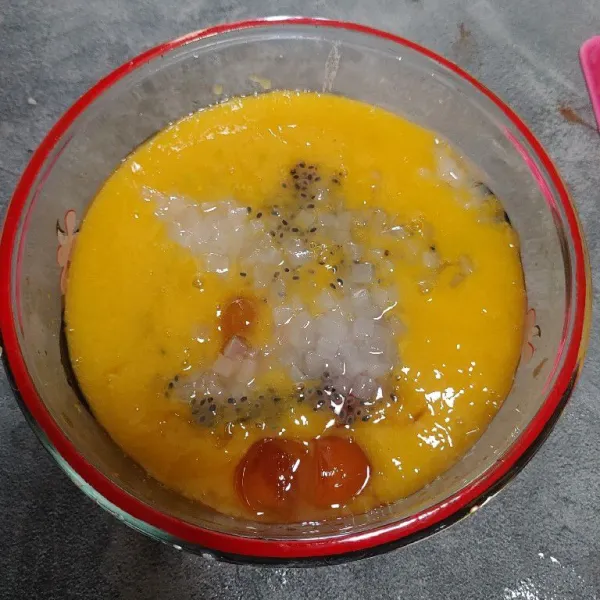 Masukkan jus mangga ke dalam mangkuk, tambahkan jelly, selasih yang sudah direndam air hangat dan nata de coco.