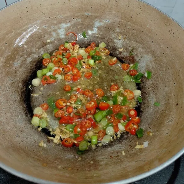 Tumis bawang putih cincang, cabe iris dan daun bawang hingga harum, beri garam dan kaldu bubuk lalu koreksi rasa.