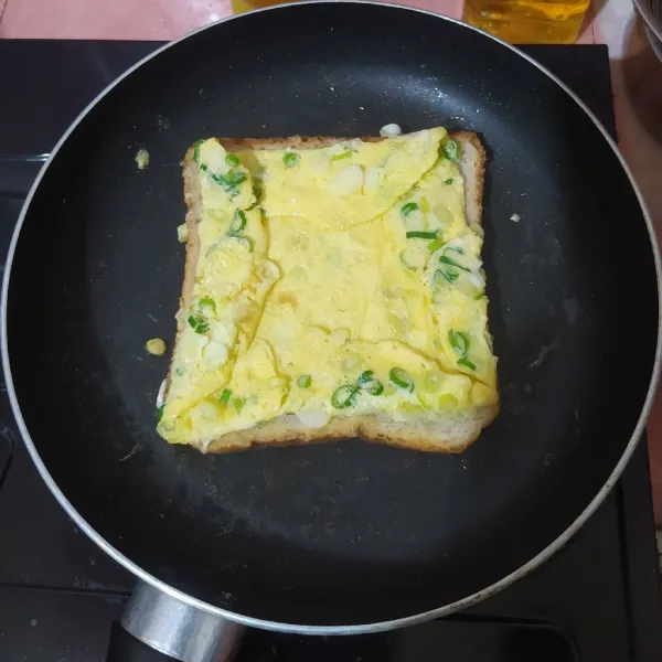 Balik kemudian lipat keempat sisi telur. Kalau bagian bawah roti sudah kecoklatan, angkat.