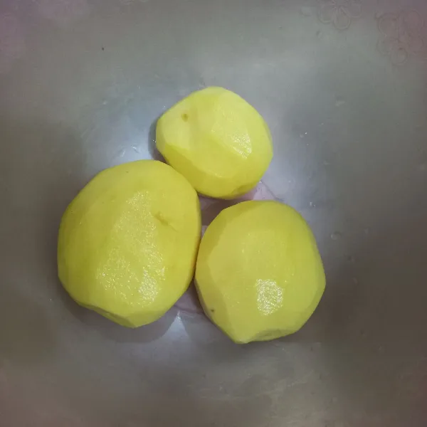 Kupas kentang dan buang kulit.