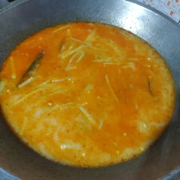 Tuang santan, aduk merata sampai mendidih, koreksi rasanya, masak hingga labu empuk, lalu angkat dan sajikan.