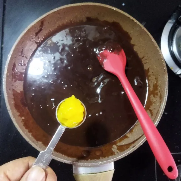 Tambahkan mentega dan vanilla ekstrak, lalu aduk kembali hingga cokelat dan mentega meleleh sempurna.